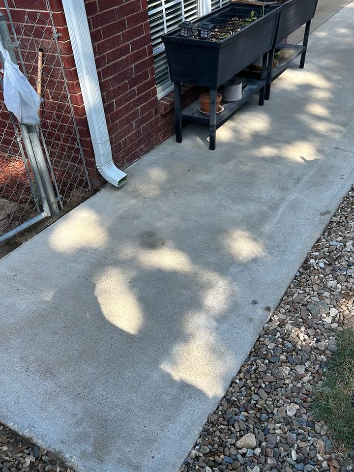The same concrete walk, pale and clean with tree shade across it, after cleaning